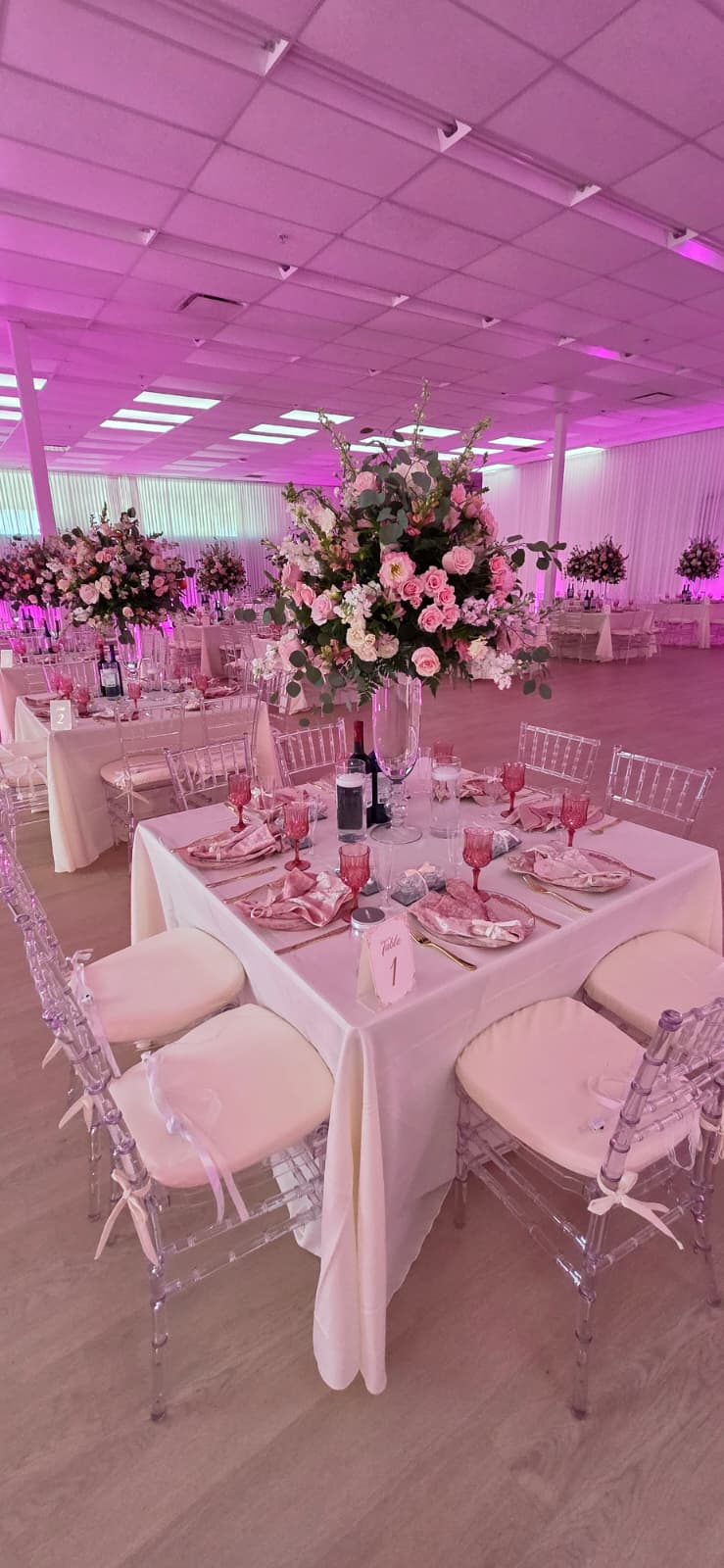 Table 1 detail with floral centerpiece and pink glassware